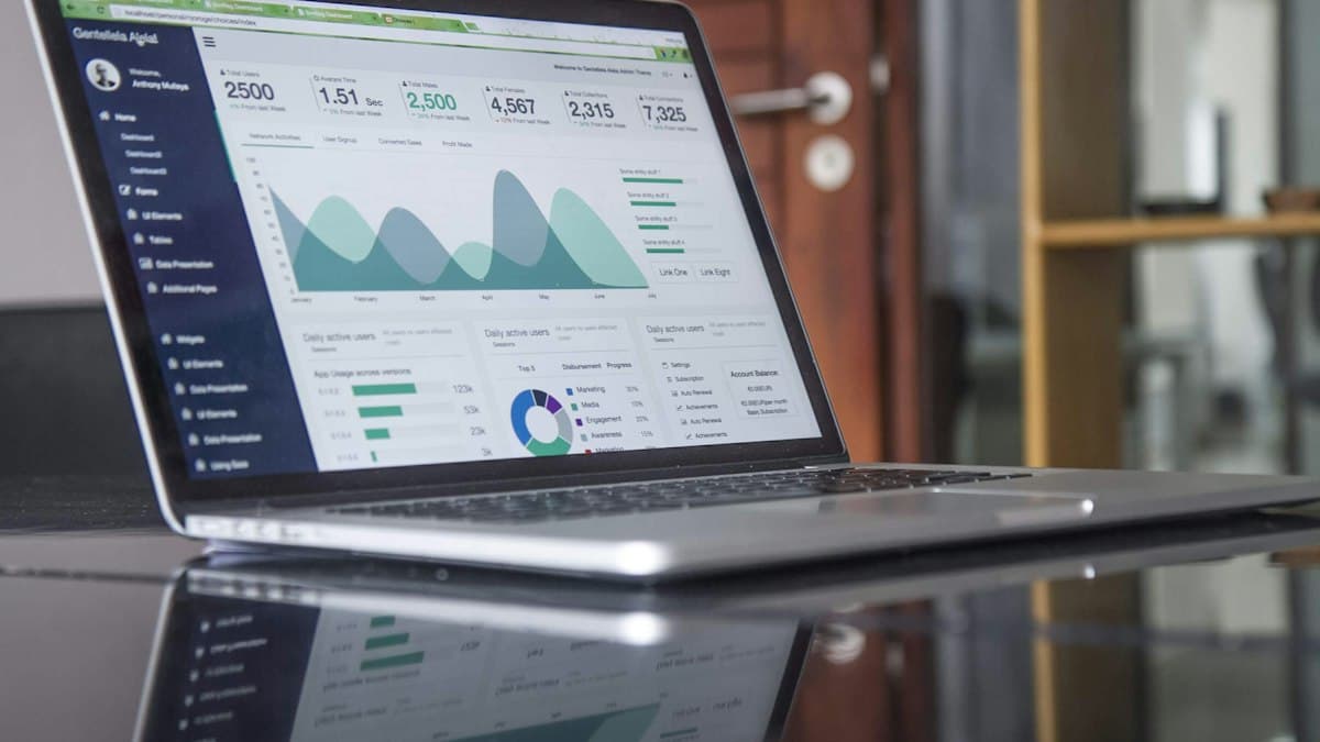 A laptop showing business charts