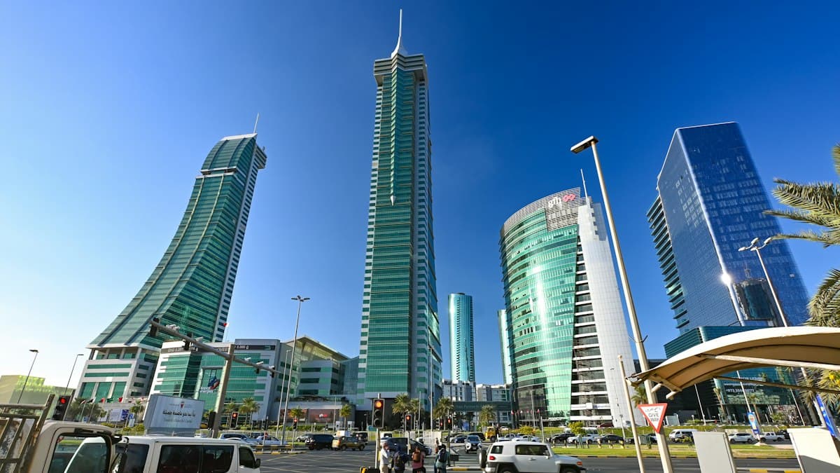 Modern office towers in Manama against a blue sky